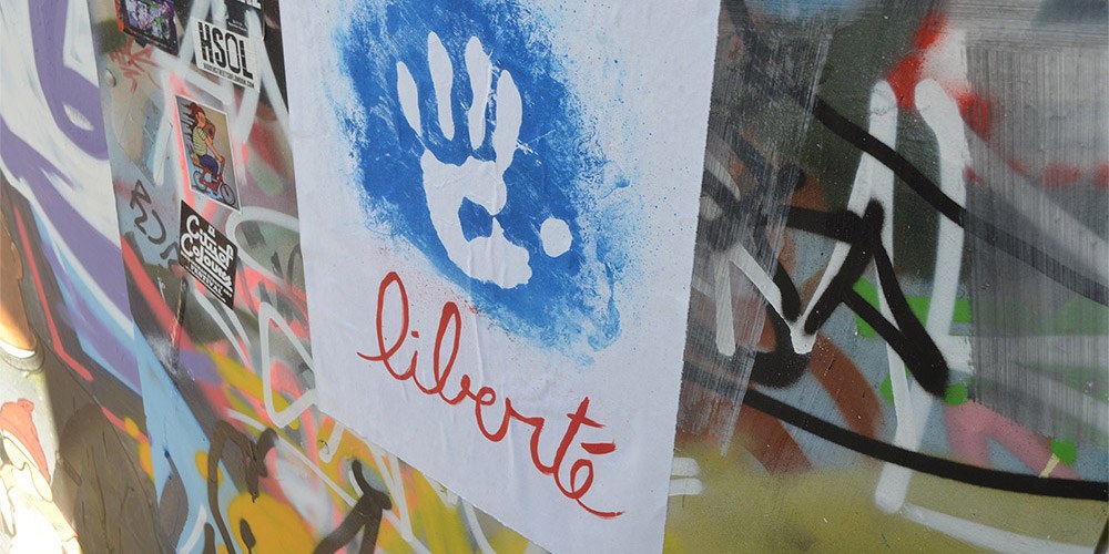 Wall covered in brightly coloured graffiti