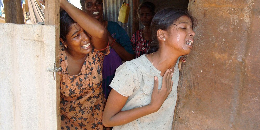 Close-up of three female victims of Sri Lanka’s Civil War in extreme distress