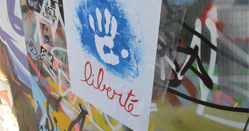 Wall covered in brightly coloured graffiti